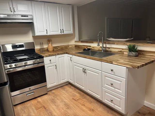 a kitchen with wooden floors and stainless steel appliances