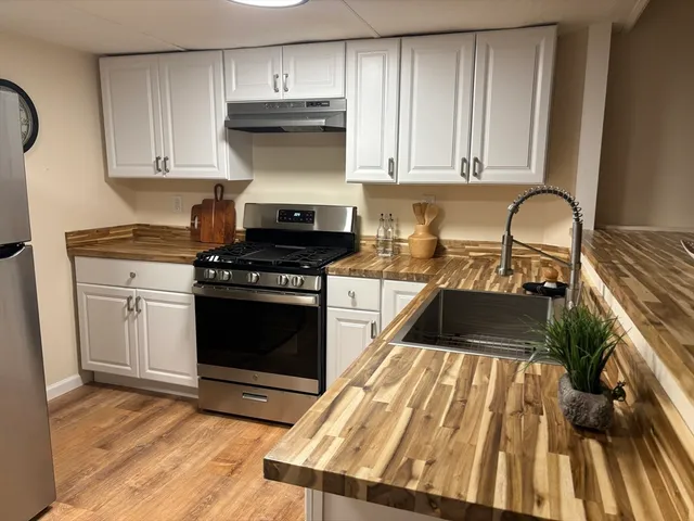 a kitchen with a stove oven and sink