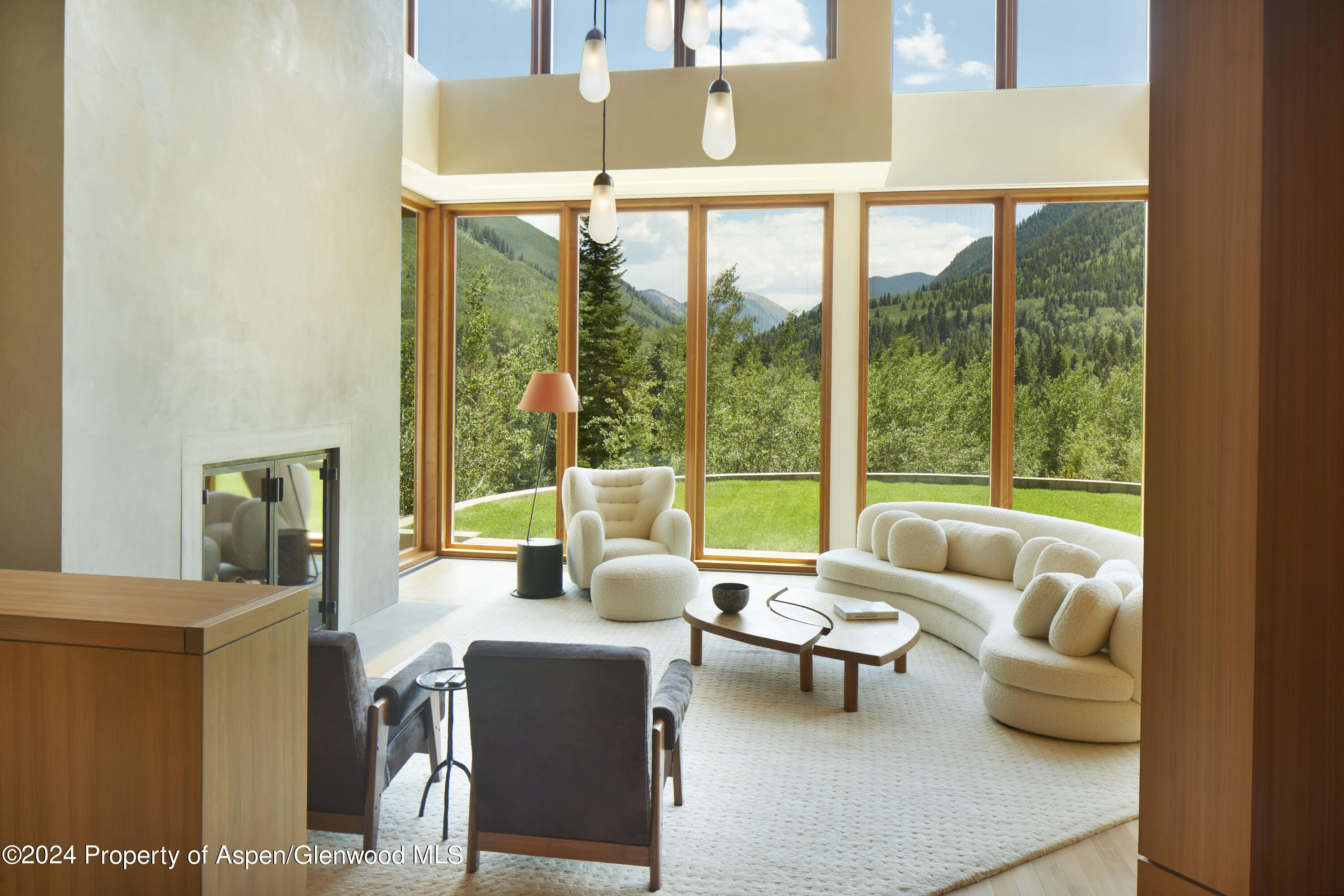 255 Conundrum Creek Road Aspen, CO 81611 - Photo 2 of 21 a living room with furniture and a floor to ceiling window