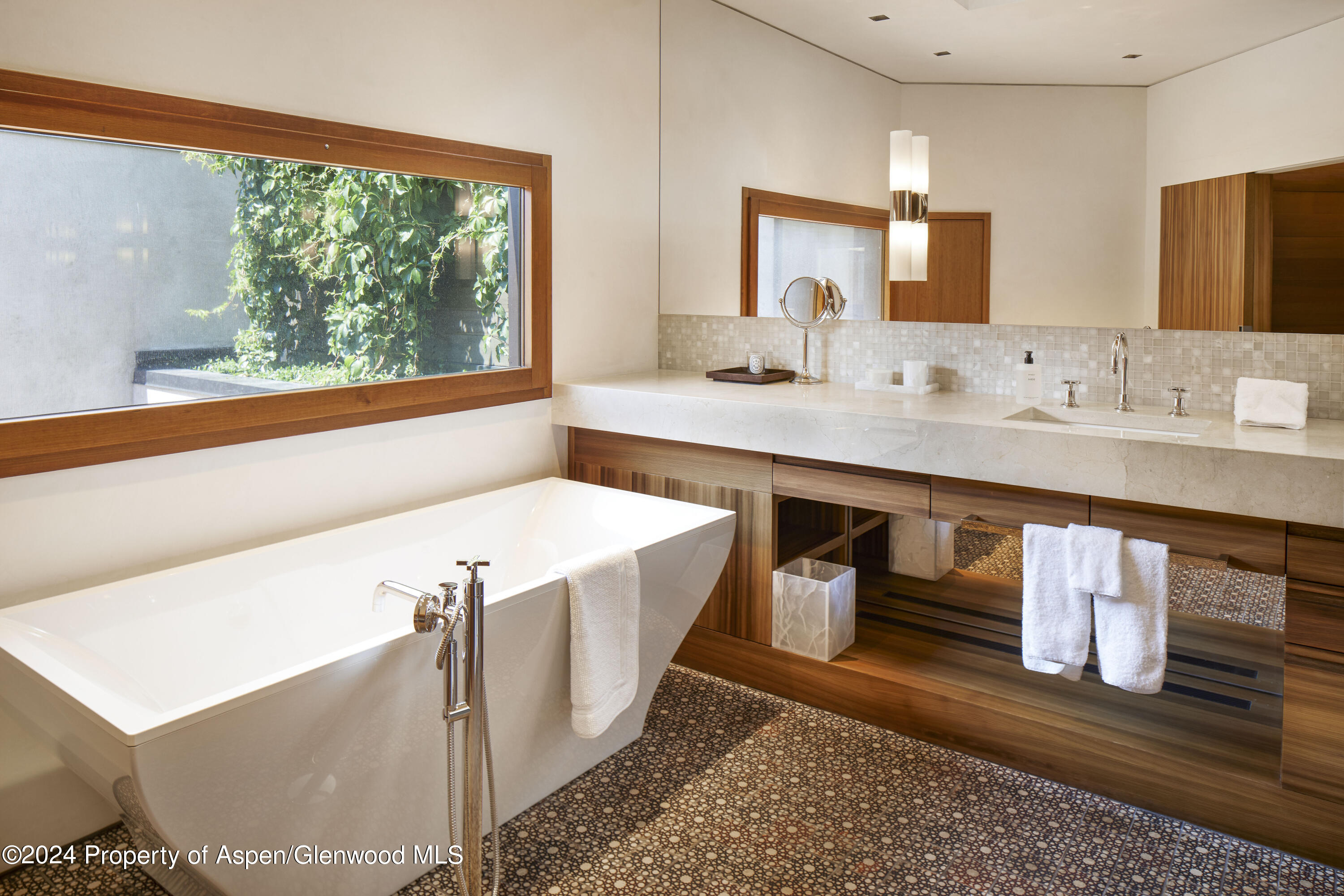 255 Conundrum Creek Road Aspen, CO 81611 - Photo 7 of 21 a bathroom with a sink a mirror and a bathtub