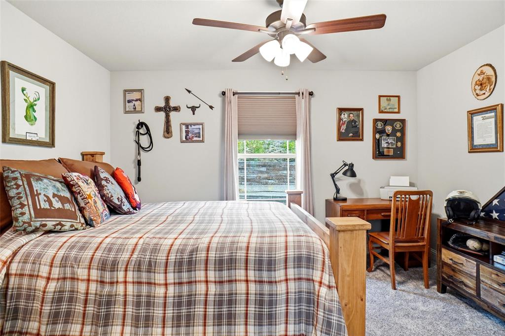 1024 Tex Lane Springtown, TX 76082 - Photo 29 of 40 a bedroom with a bed and wooden floor