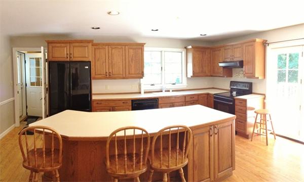 14 Johnson Road Sterling, MA 01564 - Photo 2 of 22 a kitchen with stainless steel appliances kitchen island granite countertop a refrigerator a stove a sink dishwasher with a dining table and chairs
