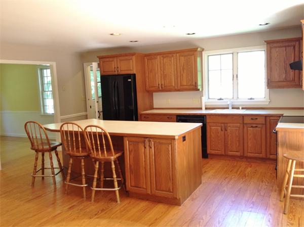 14 Johnson Road Sterling, MA 01564 - Photo 3 of 22 a kitchen with stainless steel appliances granite countertop a table chairs sink and cabinets