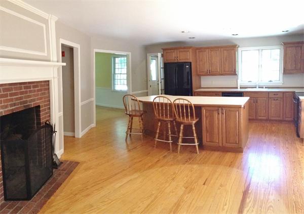 14 Johnson Road Sterling, MA 01564 - Photo 4 of 22 a kitchen with a wooden floor and a fireplace