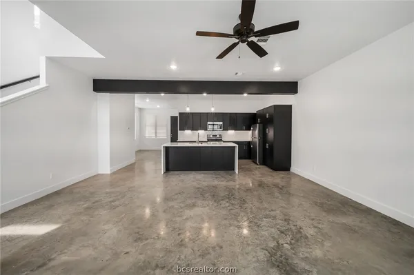 a living room with furniture and a ceiling fan