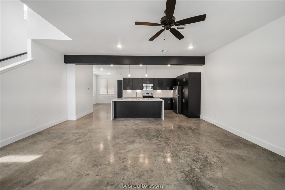213 Lynn Drive, Unit 202 Bryan, TX 77801 - Photo 2 of 28 a living room with furniture and a ceiling fan