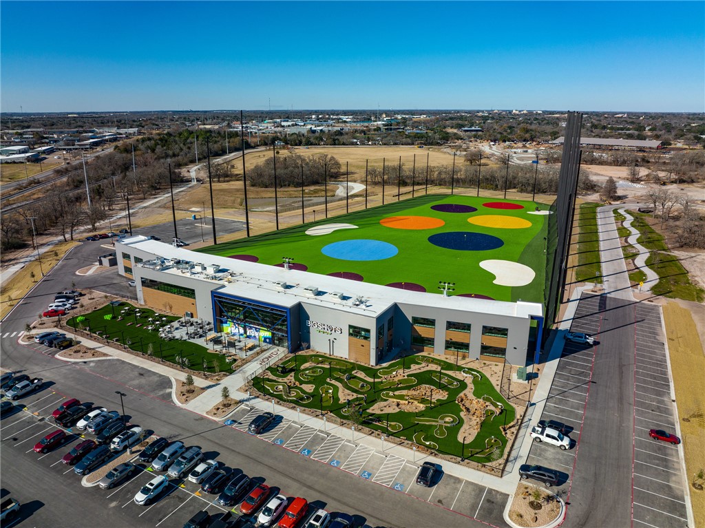 213 Lynn Drive, Unit 202 Bryan, TX 77801 - Photo 25 of 28 an aerial view of a house with a garden