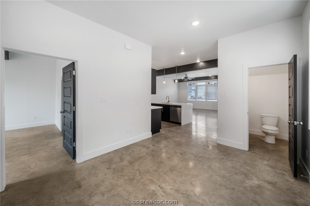 213 Lynn Drive, Unit 202 Bryan, TX 77801 - Photo 6 of 28 a view of a kitchen with refrigerator and cabinets