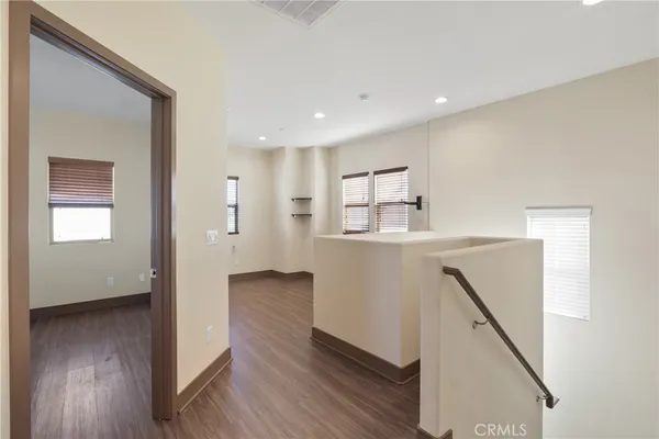 a view of hallway with wooden floor and stairs