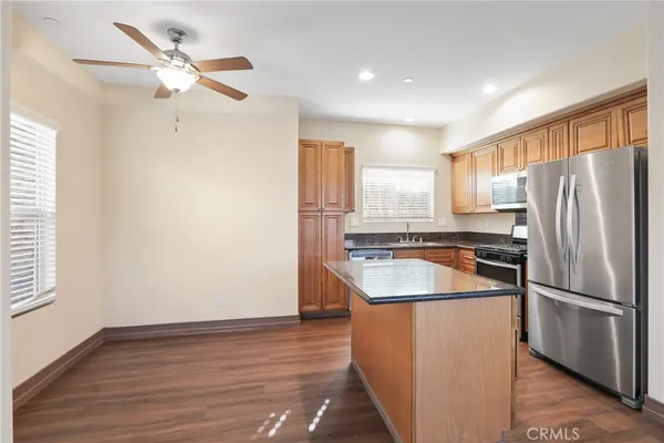 a kitchen with granite countertop a refrigerator and a sink