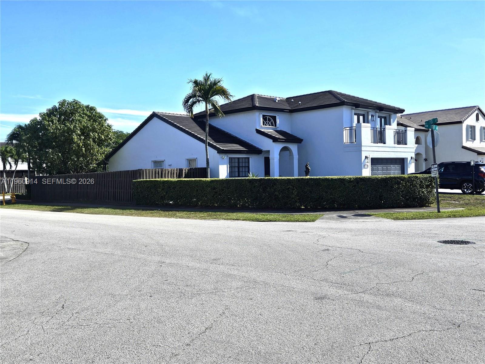 7301 Southwest 159th Avenue, Unit 1 Miami, FL 33193 - Photo 1 of 10 a front view of a house with a yard