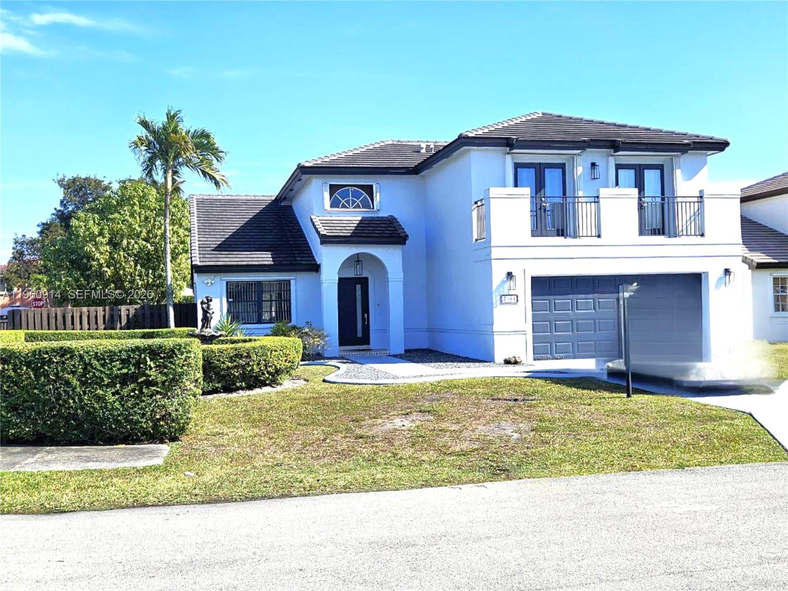 7301 Southwest 159th Avenue, Unit 1 Miami, FL 33193 - Photo 2 of 10 a front view of a house with a yard