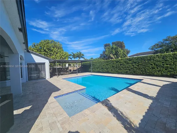 a view of a swimming pool with a yard