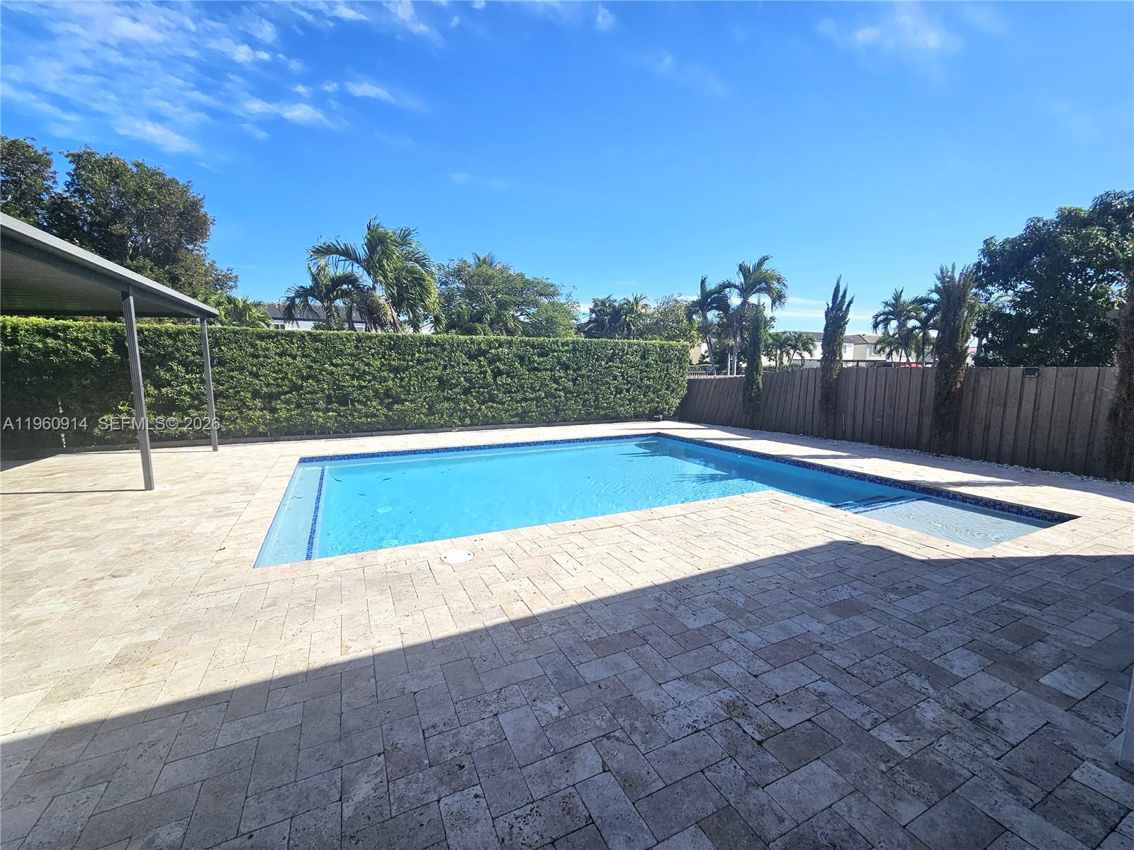 7301 Southwest 159th Avenue, Unit 1 Miami, FL 33193 - Photo 6 of 10 a view of a swimming pool with an outdoor space and seating area