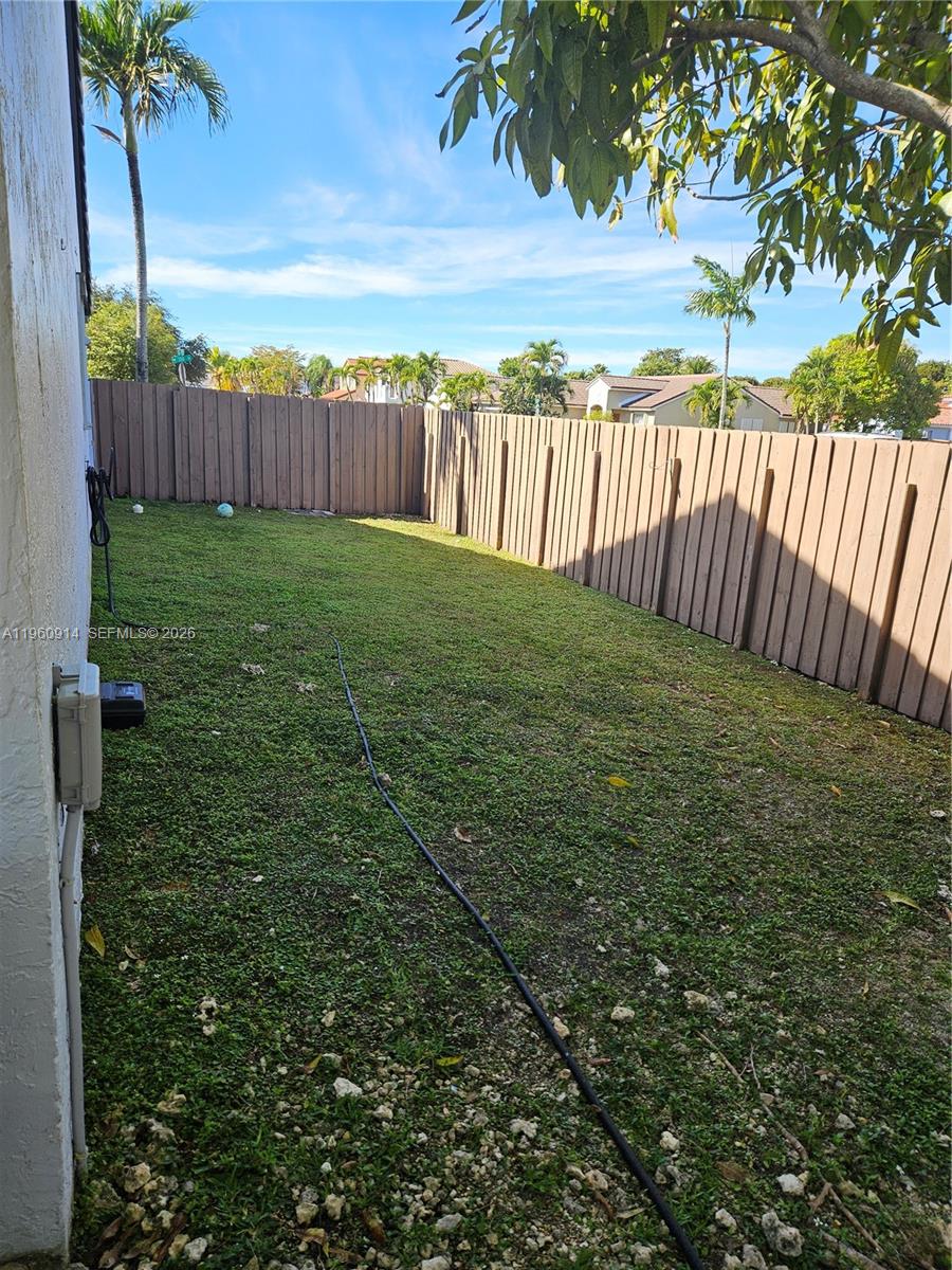 7301 Southwest 159th Avenue, Unit 1 Miami, FL 33193 - Photo 8 of 10 a view of a yard with wooden fence