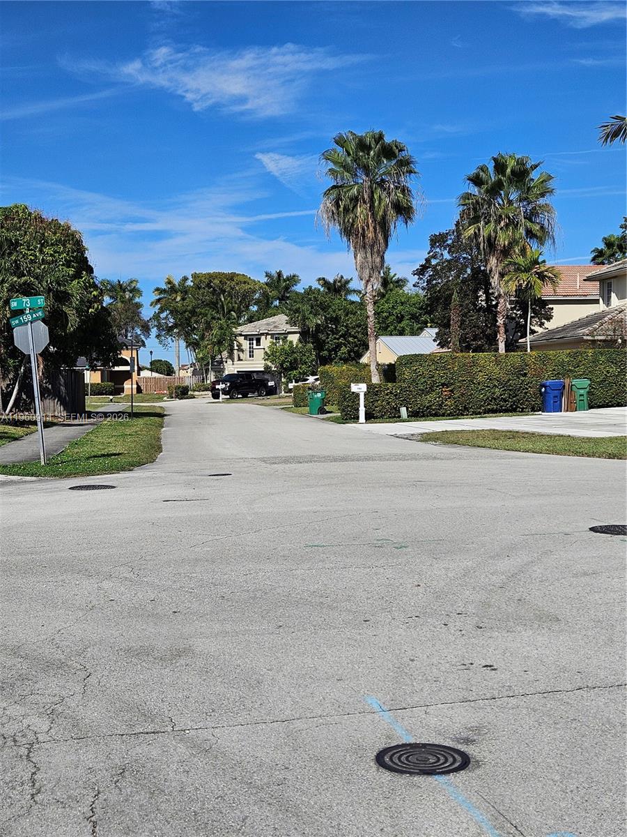 7301 Southwest 159th Avenue, Unit 1 Miami, FL 33193 - Photo 9 of 10 a view of a road with a building in the background