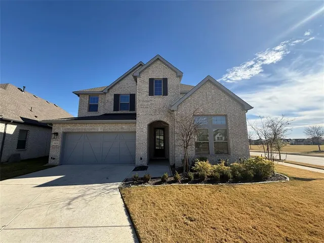 a front view of a house with yard