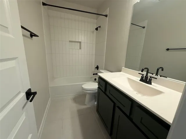 a bathroom with a double vanity sink toilet mirror and shower