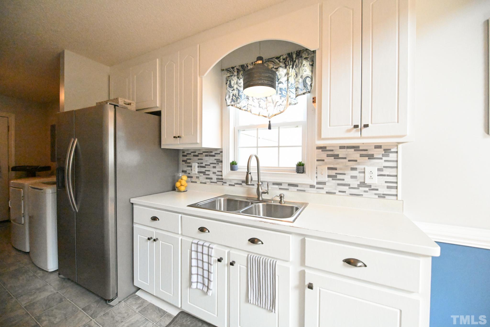 4071 Bizzell Grove Church Road Princeton, NC 27569 - Photo 14 of 53 a kitchen with white cabinets and a sink