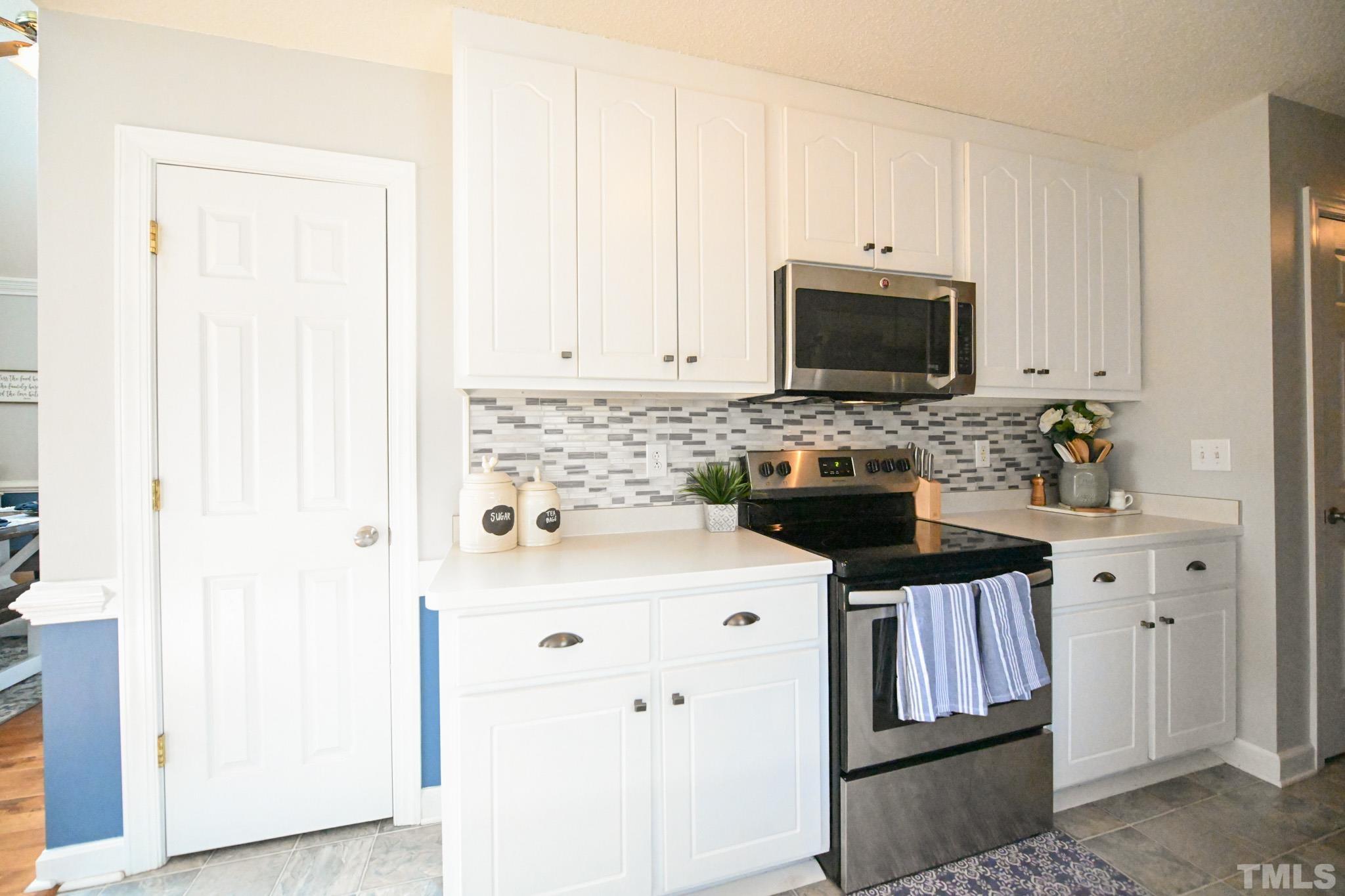 4071 Bizzell Grove Church Road Princeton, NC 27569 - Photo 15 of 53 a kitchen with granite countertop a sink a stove and cabinets