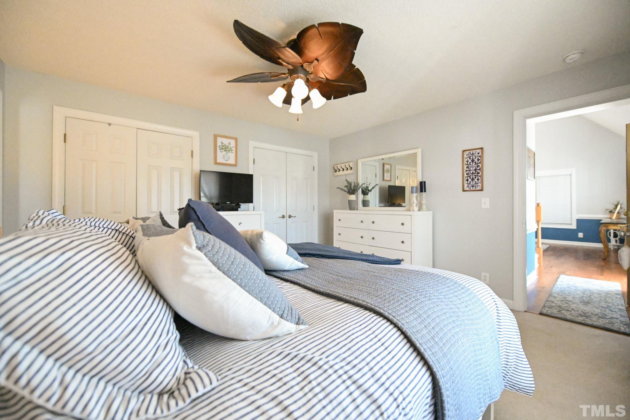 4071 Bizzell Grove Church Road Princeton, NC 27569 - Photo 29 of 53 a bedroom with a large bed and a chandelier