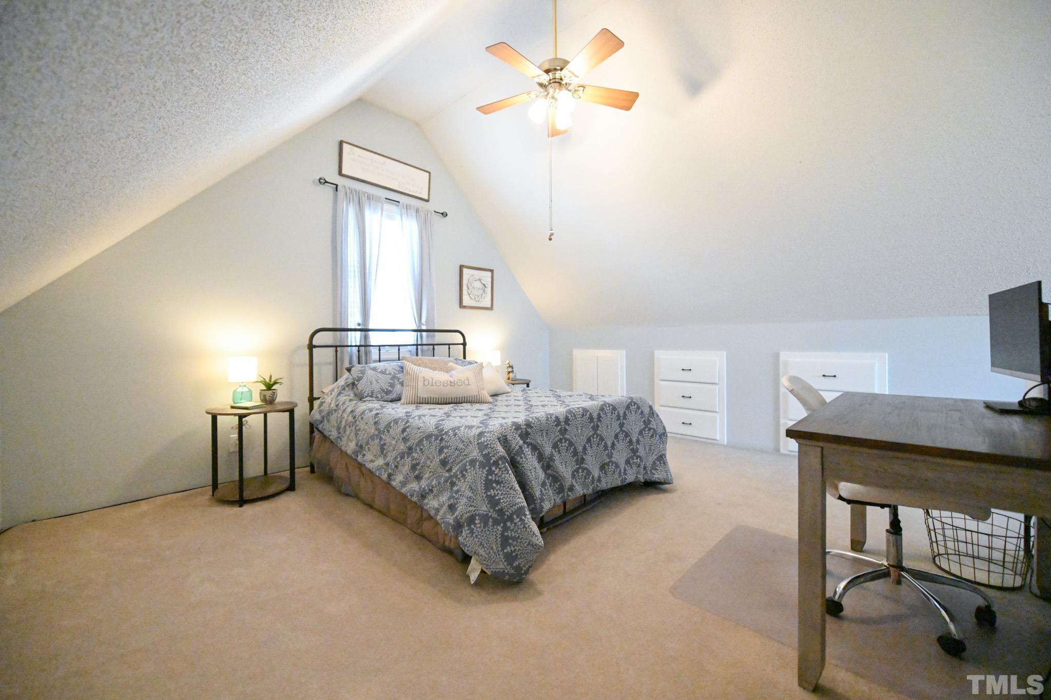 4071 Bizzell Grove Church Road Princeton, NC 27569 - Photo 40 of 53 a bedroom with a bed and a chandelier