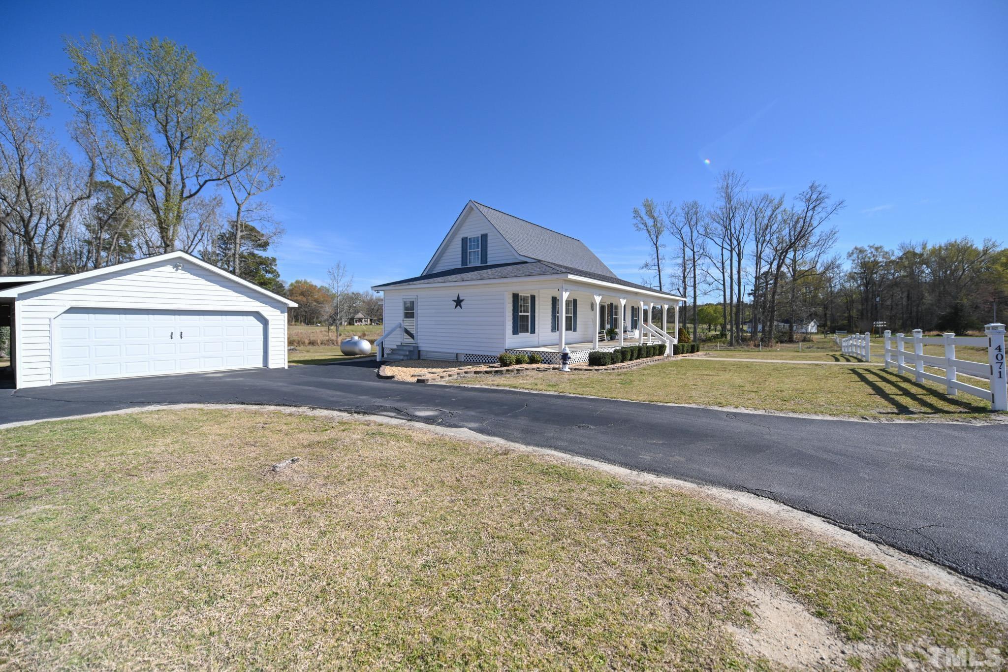 4071 Bizzell Grove Church Road Princeton, NC 27569 - Photo 4 of 53 a front view of a house with a yard and a garage