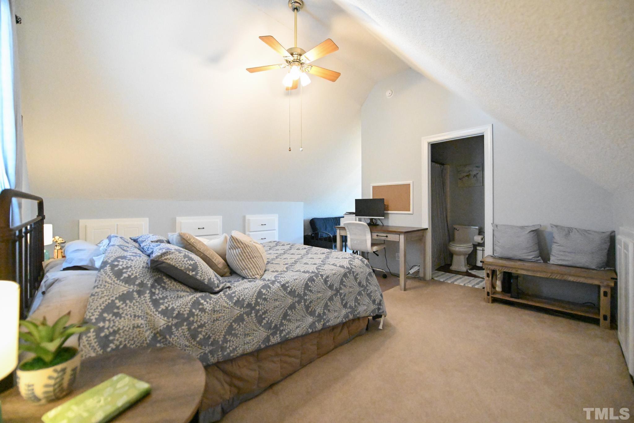 4071 Bizzell Grove Church Road Princeton, NC 27569 - Photo 41 of 53 a bedroom with a bed and a chandelier