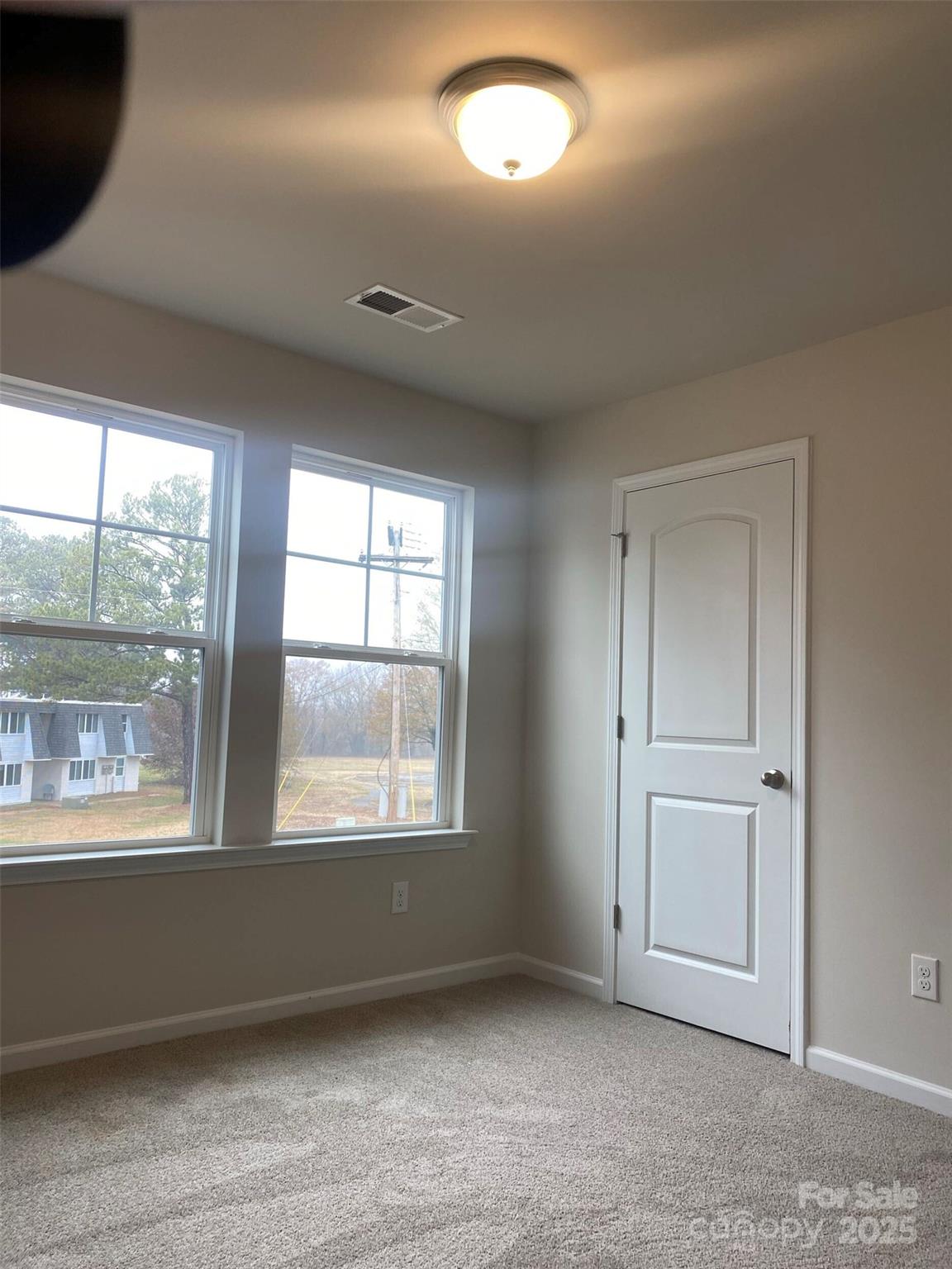 442 Phifer Road Kings Mountain, NC 28086 - Photo 11 of 16 an empty room with wooden floor and windows