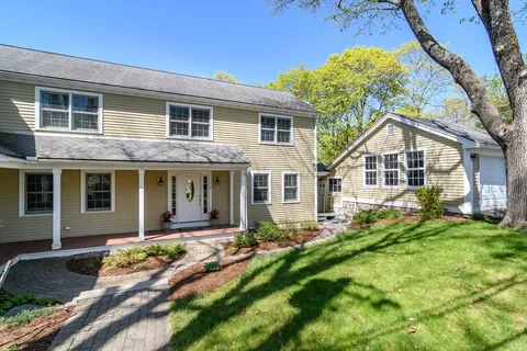a front view of house with yard and green space