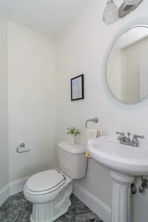 a bathroom with a sink mirror and toilet