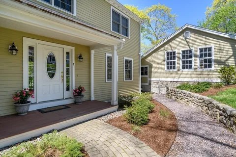a front view of a house with garden