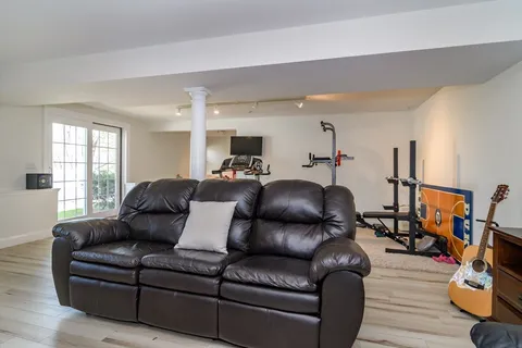 a living room with furniture and wooden floor