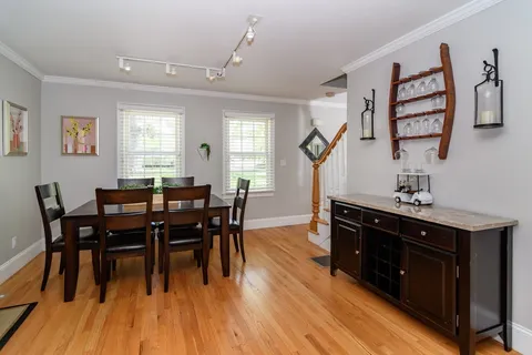 a view of a dining room with furniture and wooden floor