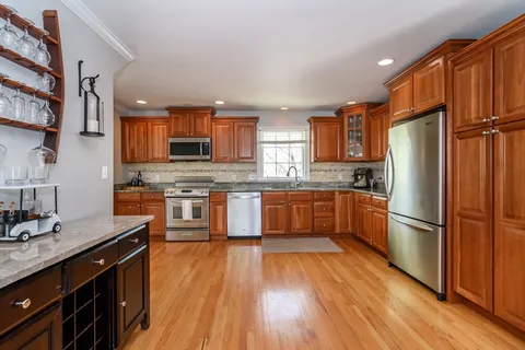 a kitchen with stainless steel appliances a refrigerator sink and microwave