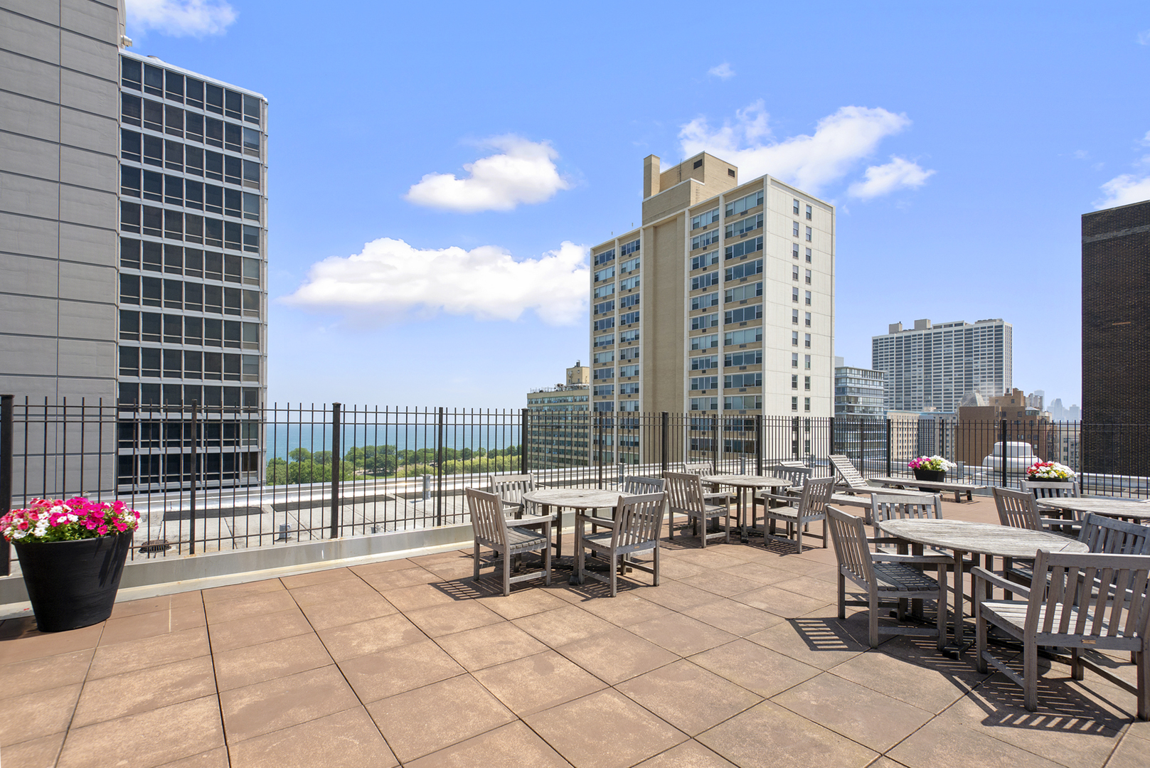 3033 North Sheridan Road, Unit 605 Chicago, IL 60657 - Photo 13 of 13 a roof deck with a barbeque and outdoor seating