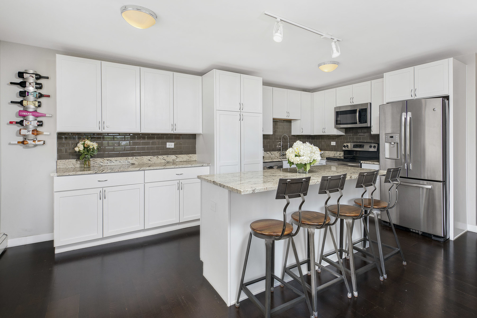 3033 North Sheridan Road, Unit 605 Chicago, IL 60657 - Photo 7 of 13 a kitchen with stainless steel appliances a stove a sink refrigerator and a cabinets