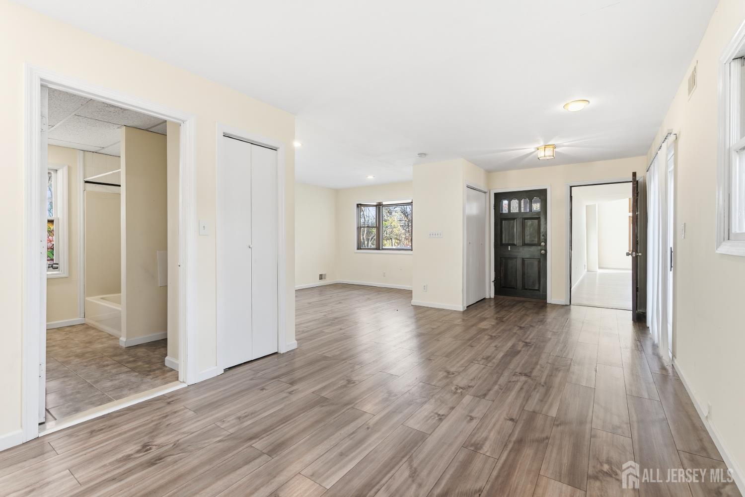 1818 Oak Tree Road Edison, NJ 08820 - Photo 12 of 15 a view of an empty room with wooden floor and a window