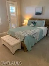 a bedroom with a bed and a night stand