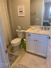 16390 Viansa Way, Unit 1202 Naples, FL 34110 - Photo 12 of 26 a bathroom with a sink a toilet and a mirror