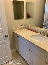 16390 Viansa Way, Unit 1202 Naples, FL 34110 - Photo 14 of 26 a bathroom with a sink and a mirror