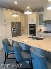 a view of kitchen with sink and breakfast area