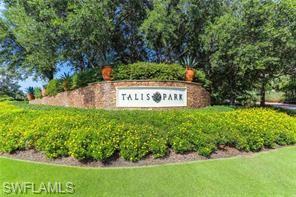 16390 Viansa Way, Unit 1202 Naples, FL 34110 - Photo 24 of 26 a sign that is sitting in front of a tree