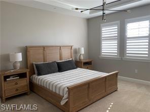 16390 Viansa Way, Unit 1202 Naples, FL 34110 - Photo 9 of 26 a bedroom with a bed and a window