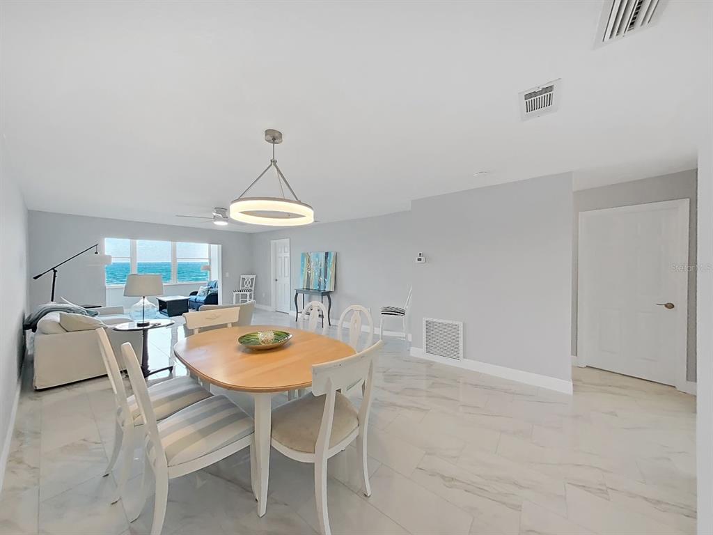 7 Dunoon Place, Unit 104 Dunedin, FL 34698 - Photo 11 of 45 a dining room with furniture and a window