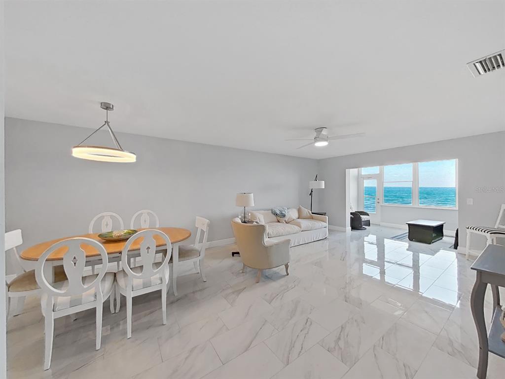 7 Dunoon Place, Unit 104 Dunedin, FL 34698 - Photo 14 of 45 a view of a dining room with furniture wooden floor and chandelier