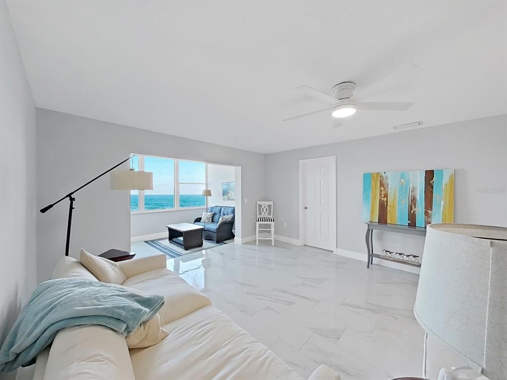 7 Dunoon Place, Unit 104 Dunedin, FL 34698 - Photo 16 of 45 a living room with furniture and a large window