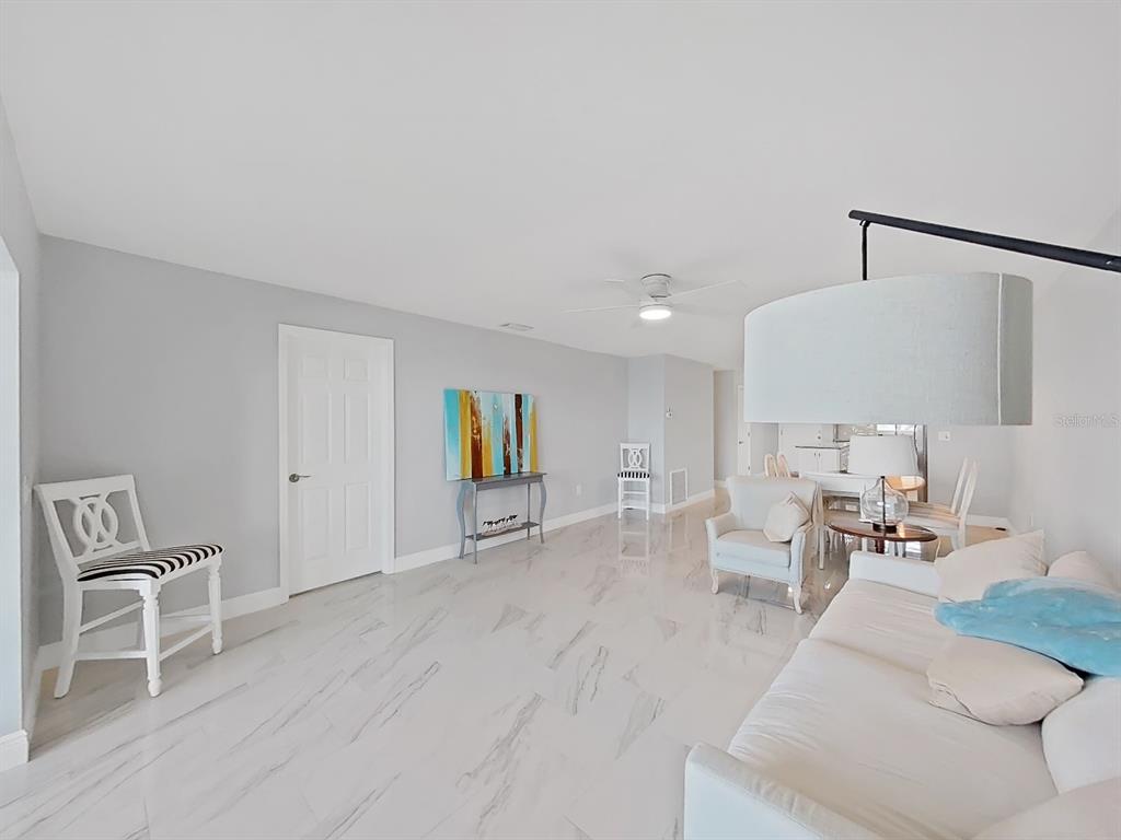 7 Dunoon Place, Unit 104 Dunedin, FL 34698 - Photo 19 of 45 a living room with furniture and a wooden floor