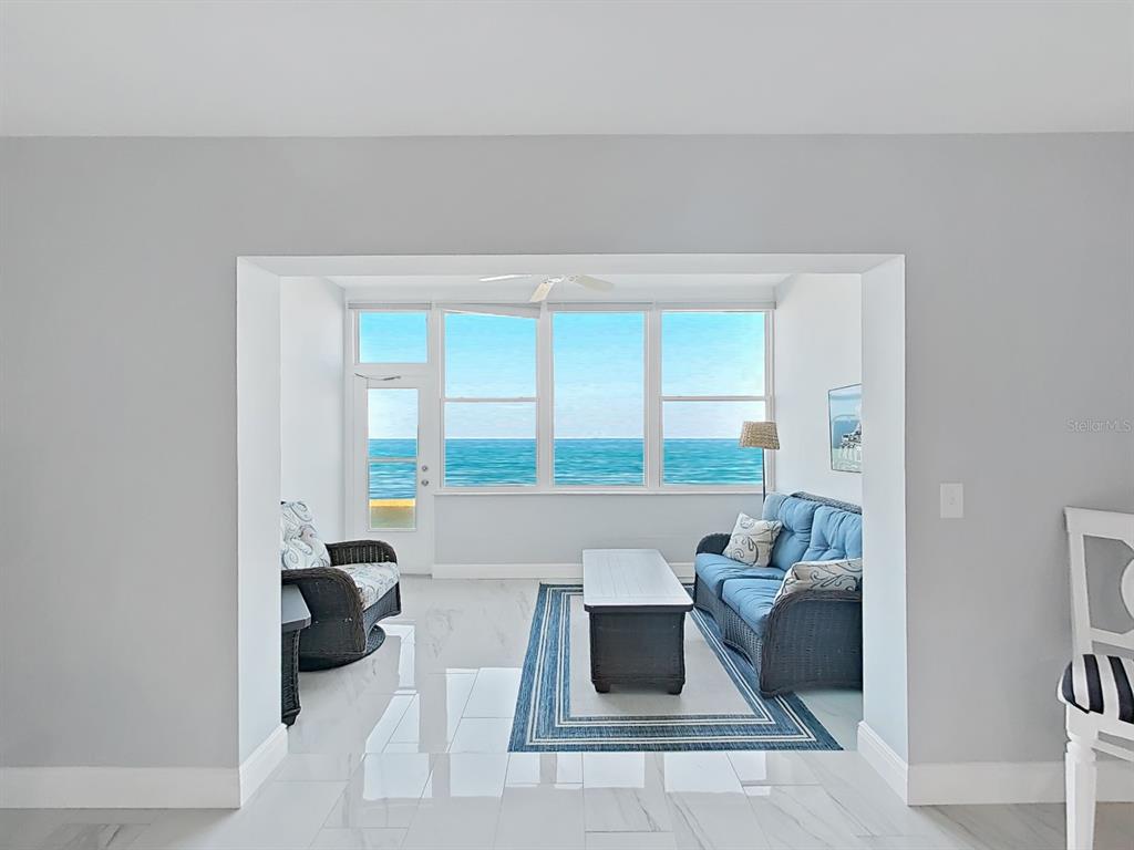 7 Dunoon Place, Unit 104 Dunedin, FL 34698 - Photo 20 of 45 a living room with furniture and a large window