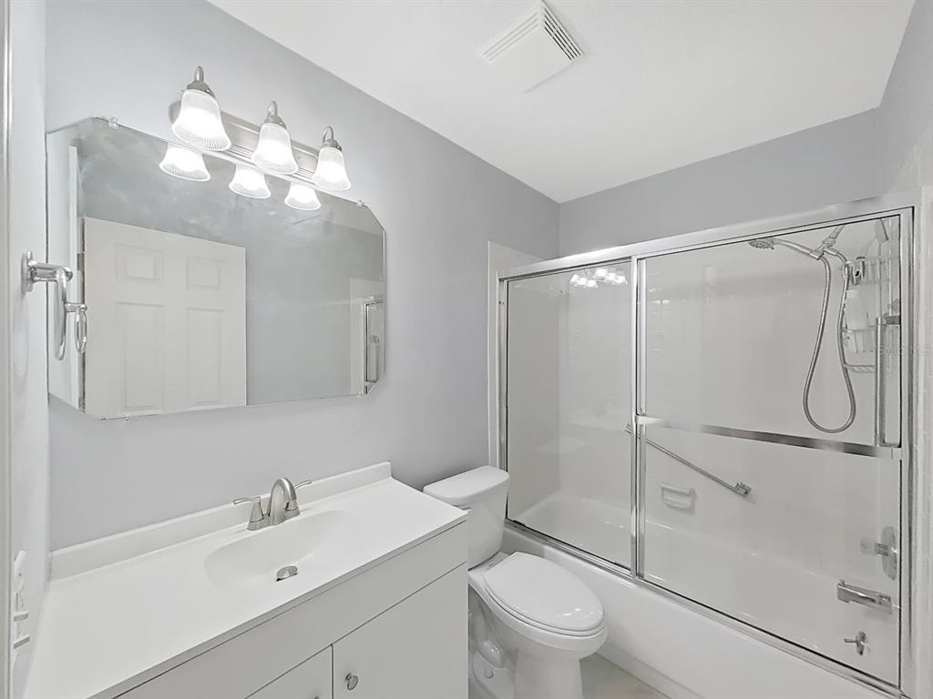 7 Dunoon Place, Unit 104 Dunedin, FL 34698 - Photo 24 of 45 a bathroom with a sink a toilet and shower